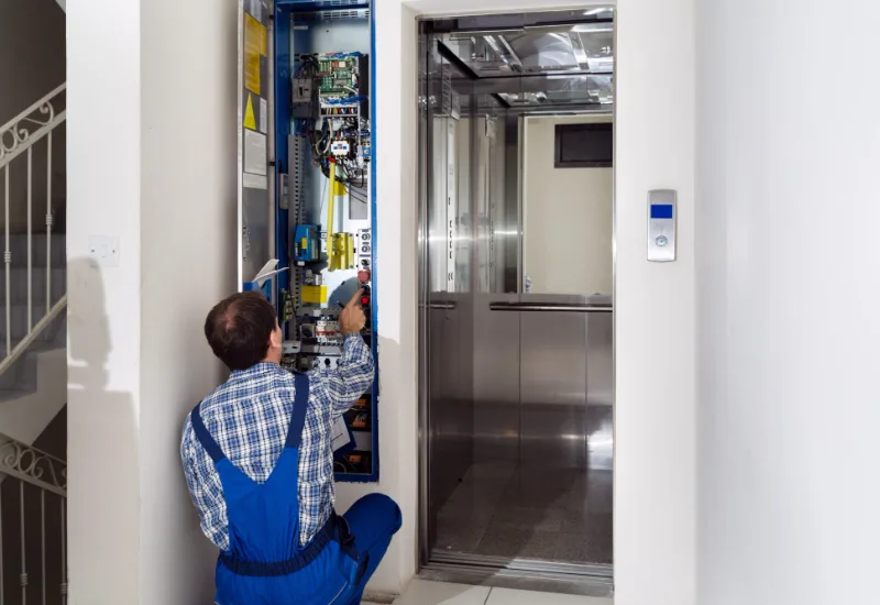 Techniker prüft den Schaltschrank einer Aufzugsanlage